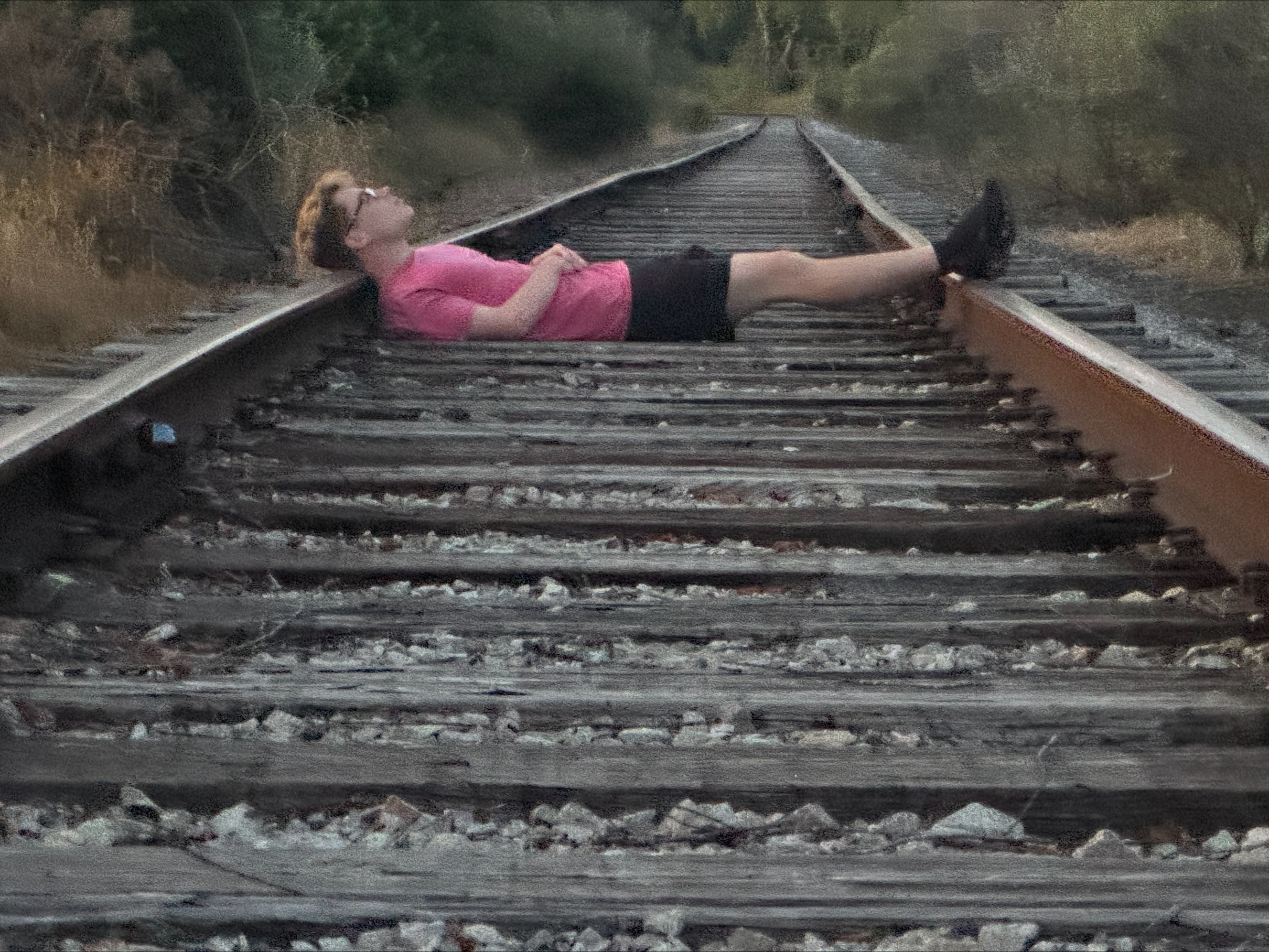 Me laying down on a train track